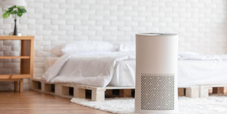 A quality air purifier in a master bedroom removing dust particles from the indoor air